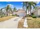 Charming single-story home boasting a well-kept lawn, a two-car garage, and mature landscaping, creating curb appeal at 2960 Kokomo Loop, Haines City, FL 33844