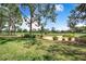 Picturesque golf course view with lush greenery, mature trees, and a clear blue sky, perfect for outdoor enthusiasts at 2960 Kokomo Loop, Haines City, FL 33844