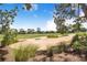 Beautiful golf course landscape with rolling green hills, mature trees, and manicured sand traps, a golfer's paradise at 2960 Kokomo Loop, Haines City, FL 33844