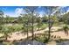 View of golf course; large sand traps are visible between homes and native trees at 2960 Kokomo Loop, Haines City, FL 33844