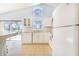 A well-lit white kitchen features a breakfast bar and a view of the screened-in pool at 2960 Kokomo Loop, Haines City, FL 33844