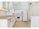 Bright kitchen with white cabinetry, modern appliances, and tile flooring at 2960 Kokomo Loop, Haines City, FL 33844