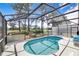 Relaxing screened-in pool with views of the golf course and mature landscaping at 2960 Kokomo Loop, Haines City, FL 33844