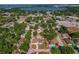 An aerial view shows the home's location, surrounded by trees, with a nearby lake in the distance at 3022 Lantana Rd, Auburndale, FL 33823