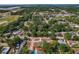 An aerial view showcases the property, surrounded by lush trees and other homes in the neighborhood at 3022 Lantana Rd, Auburndale, FL 33823