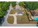 An aerial view of a one story home with a long driveway, showcasing its well-maintained lawn at 3022 Lantana Rd, Auburndale, FL 33823