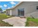 Back of the home shows the patio, sliding glass door and grassy backyard at 3022 Lantana Rd, Auburndale, FL 33823