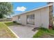 Back exterior of the home with a concrete patio, grassy area, and neutral paint at 3022 Lantana Rd, Auburndale, FL 33823