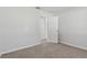 Bedroom showcases neutral color scheme, carpeted floor, and a door leading to another room at 3022 Lantana Rd, Auburndale, FL 33823