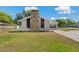 Charming single-story home with a stone chimney and well-maintained front yard on a beautiful day at 3022 Lantana Rd, Auburndale, FL 33823