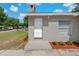 Charming front door featuring white door, chimney, and manicured mulch beds at 3022 Lantana Rd, Auburndale, FL 33823