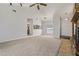 Bright living room with neutral carpet, ceiling fan, and an open layout to the kitchen at 3022 Lantana Rd, Auburndale, FL 33823