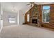 Inviting living room featuring a stone fireplace, vaulted ceilings, ceiling fan and natural light at 3022 Lantana Rd, Auburndale, FL 33823