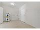 Unfinished room features block walls, light floors and access to a hallway at 3022 Lantana Rd, Auburndale, FL 33823