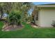 Well-maintained backyard with lush green grass, mature landscaping, and manicured mulch beds at 3158 Beauchamp Ct, Winter Haven, FL 33884