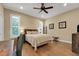 Bedroom featuring wood-look floors, ceiling fan, shuttered windows, and rustic decor at 3158 Beauchamp Ct, Winter Haven, FL 33884