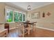 Cozy breakfast nook with a bright window, wooden table, natural light, and hardwood flooring at 3158 Beauchamp Ct, Winter Haven, FL 33884