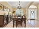 Formal dining room featuring a wooden table, chandelier, traditional decor, and large windows with views at 3158 Beauchamp Ct, Winter Haven, FL 33884