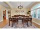 Well-appointed dining room with wood floors, classic decor, dining table, and access to other living areas at 3158 Beauchamp Ct, Winter Haven, FL 33884