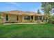 Lush green lawn and mature landscaping surrounding home's exterior with an inviting screened in porch at 3158 Beauchamp Ct, Winter Haven, FL 33884