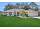 Charming single-story home with a well-maintained lawn, mature landscaping, and a welcoming two-car garage at 3158 Beauchamp Ct, Winter Haven, FL 33884