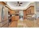 Spacious kitchen with stainless steel appliances, granite countertops, custom cabinetry, and open layout at 3158 Beauchamp Ct, Winter Haven, FL 33884