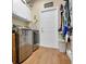 Well-equipped laundry room with stainless steel washer and dryer, cabinet space, and wood-look tile flooring at 3158 Beauchamp Ct, Winter Haven, FL 33884