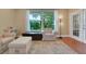 Cozy seating area with comfortable armchairs, a large window, and natural light creating a relaxing space at 3158 Beauchamp Ct, Winter Haven, FL 33884
