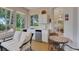 Relaxing sunroom featuring a kitchenette, table, chairs, and views of nature, perfect for enjoying the outdoors at 3158 Beauchamp Ct, Winter Haven, FL 33884