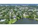 Aerial view showcases lakefront properties, lush landscaping, and neighborhood streets at 333 Lake Otis Se Dr, Winter Haven, FL 33880