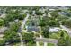 Aerial view of residences on tree-lined streets featuring well maintained yards and a neighborhood pool at 333 Lake Otis Se Dr, Winter Haven, FL 33880