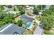 Aerial view of home with a backyard pool, lush landscaping, and a private setting at 333 Lake Otis Se Dr, Winter Haven, FL 33880