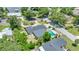 Aerial shot of home featuring a backyard pool with lake views and mature trees at 333 Lake Otis Se Dr, Winter Haven, FL 33880
