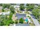 Lush aerial view of home showcases large backyard, refreshing pool and mature trees at 333 Lake Otis Se Dr, Winter Haven, FL 33880