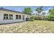 Exterior of the home with a view of the backyard and landscaping at 333 Lake Otis Se Dr, Winter Haven, FL 33880
