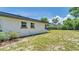 Home exterior showing backyard with grass and shrubbery at 333 Lake Otis Se Dr, Winter Haven, FL 33880