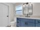 Bathroom featuring a blue vanity, a white quartz countertop, and modern fixtures at 333 Lake Otis Se Dr, Winter Haven, FL 33880