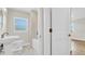Bathroom featuring a pedestal sink, toilet, tub and shower with a tile surround, and hexagon-shaped flooring at 333 Lake Otis Se Dr, Winter Haven, FL 33880