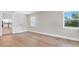 Bedroom with hardwood floors, two windows for natural light and a glimpse of the kitchen at 333 Lake Otis Se Dr, Winter Haven, FL 33880
