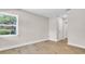 Comfortable bedroom with laminate flooring, neutral walls, and natural light enhancing the calming atmosphere at 333 Lake Otis Se Dr, Winter Haven, FL 33880