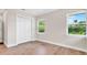 Bright bedroom featuring a spacious closet, light hardwood floors, and natural light at 333 Lake Otis Se Dr, Winter Haven, FL 33880