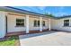 Close-up of the home's entrance featuring brick and white columns at 333 Lake Otis Se Dr, Winter Haven, FL 33880