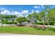 Inviting home exterior featuring a well-maintained lawn and a decorative tree at 333 Lake Otis Se Dr, Winter Haven, FL 33880