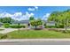 Charming home with a manicured lawn, mature trees, and neatly trimmed hedges at 333 Lake Otis Se Dr, Winter Haven, FL 33880
