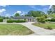 Charming single-story home boasts a well-manicured lawn and a circular driveway at 333 Lake Otis Se Dr, Winter Haven, FL 33880
