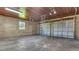Spacious three-car garage with brick walls, a wood ceiling, and an open floor plan at 333 Lake Otis Se Dr, Winter Haven, FL 33880