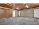 Three-car garage featuring brick walls, a wood ceiling, and access doors at 333 Lake Otis Se Dr, Winter Haven, FL 33880