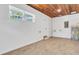 Garage featuring concrete floors, white walls, a water heater, and wood-look floors at 333 Lake Otis Se Dr, Winter Haven, FL 33880