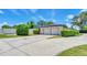 Spacious two-car garage with a long driveway and neatly trimmed landscaping at 333 Lake Otis Se Dr, Winter Haven, FL 33880