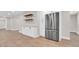 Kitchen featuring a stainless steel refrigerator, wood-look floors, and white cabinetry at 333 Lake Otis Se Dr, Winter Haven, FL 33880
